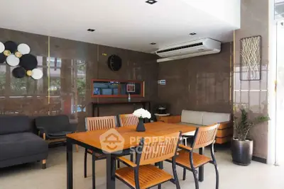 Modern living room with stylish furniture and large windows offering natural light.