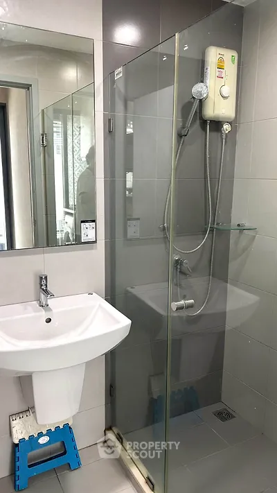 Modern bathroom with glass shower enclosure and sleek fixtures