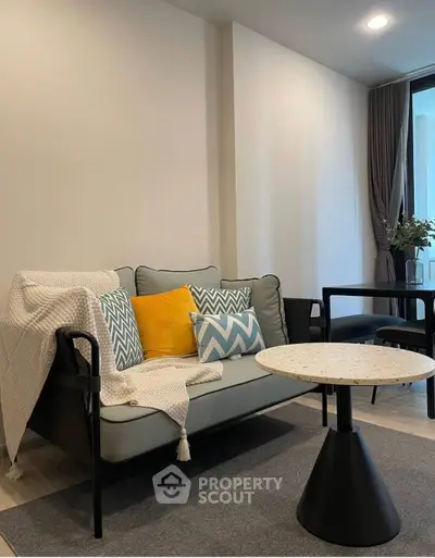 Modern living room with stylish sofa and chic decor in a cozy apartment setting.