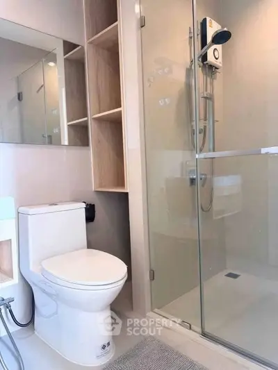 Modern bathroom with glass shower and sleek fixtures in a contemporary apartment.