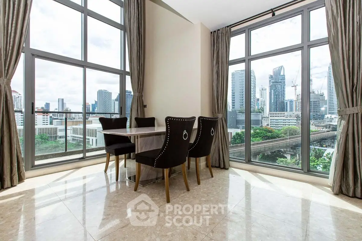Luxurious dining area with stunning city view and elegant furnishings.