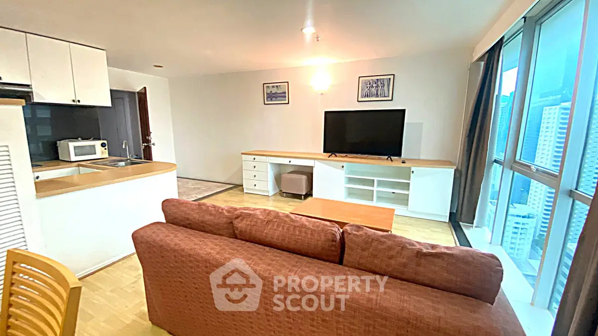 Spacious living room with modern furniture and city view, perfect for urban living.