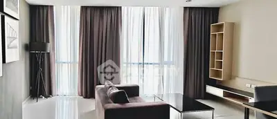 Spacious modern living room with large windows and elegant furnishings.