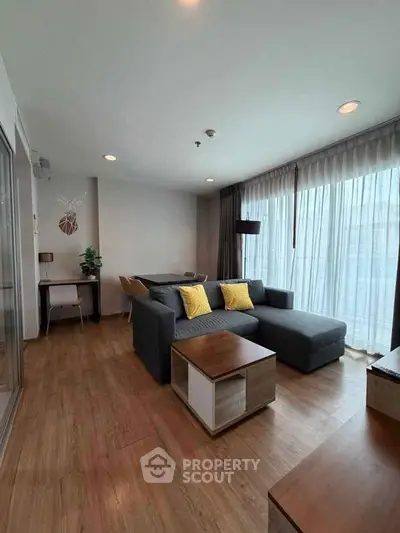 Modern living room with stylish decor and large windows for natural light.