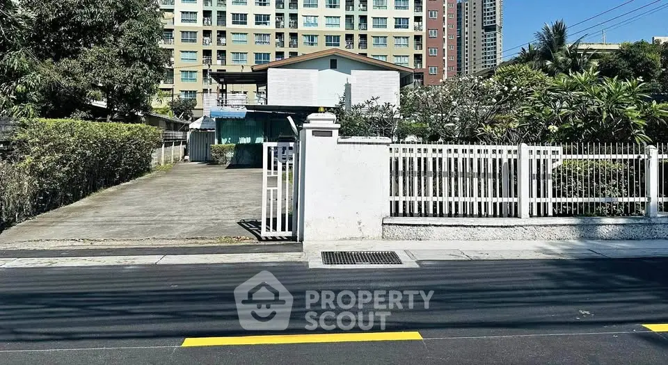 Charming suburban home with gated driveway and lush greenery, perfect for family living.