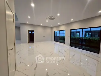 Spacious modern living room with marble flooring and large windows