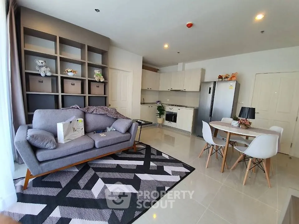 Modern living room with stylish furniture and open kitchen layout