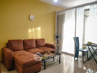 Cozy living room with brown sofa and glass sliding doors leading to balcony