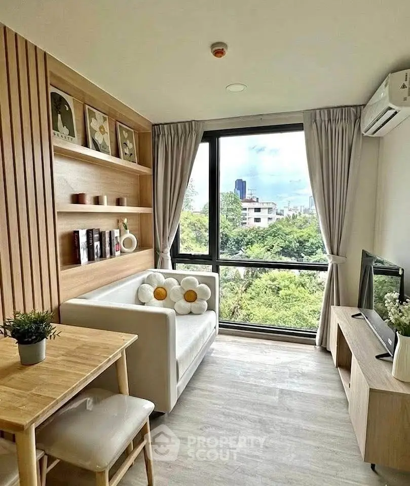 Chic modern living room with city view, cozy seating, and stylish decor in a high-rise apartment.