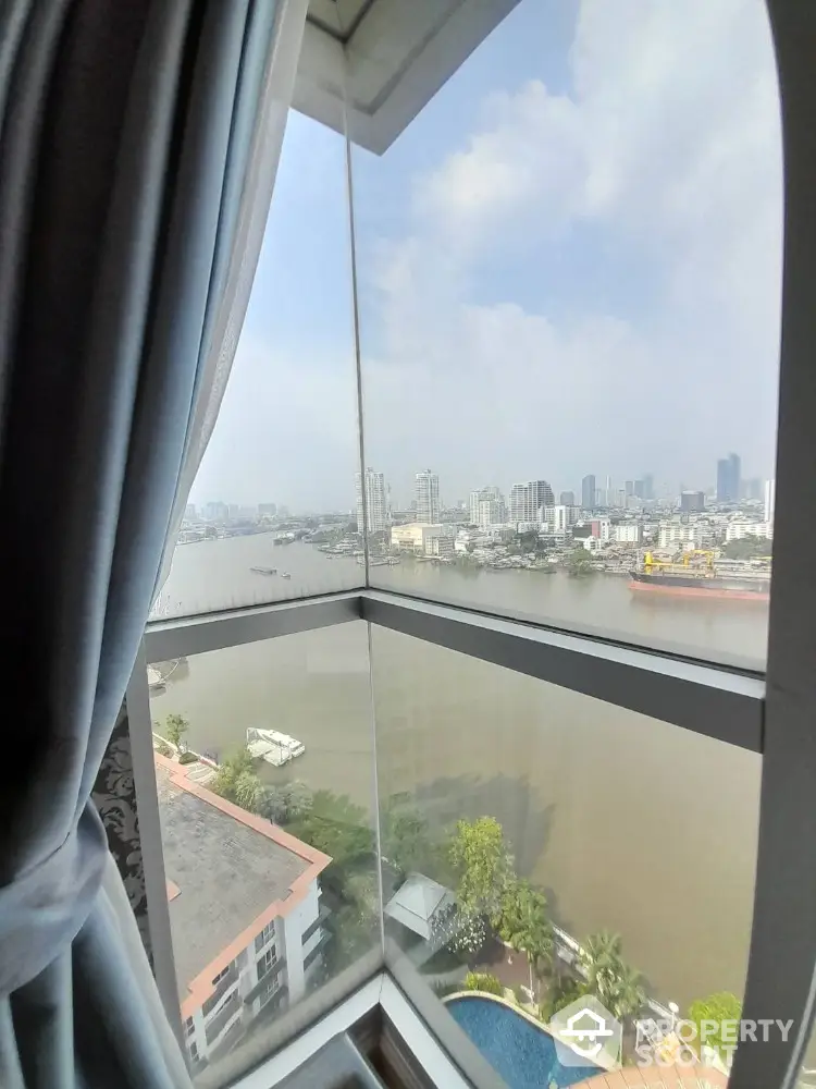 Stunning river view from high-rise apartment window with city skyline