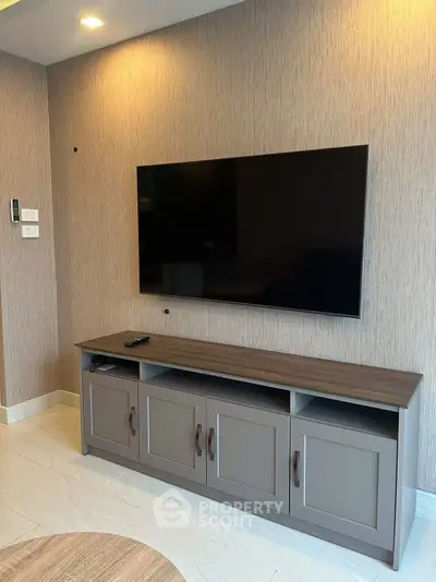 Modern living room with sleek TV setup and stylish cabinetry