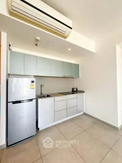 Modern minimalist kitchen with sleek cabinetry and stainless steel appliances.