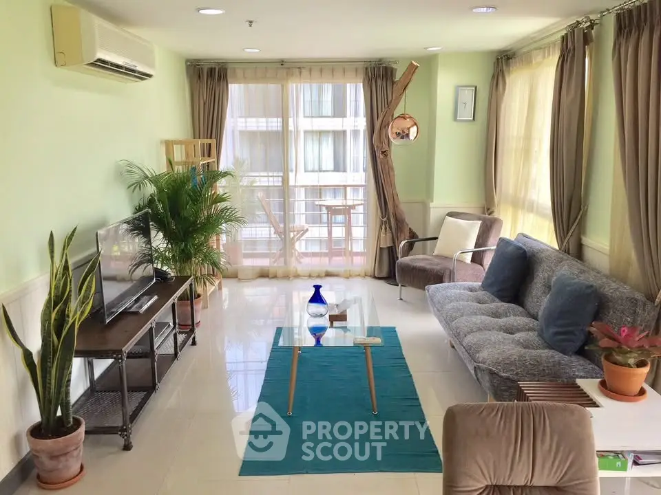 Spacious living room with modern decor and large windows offering natural light.