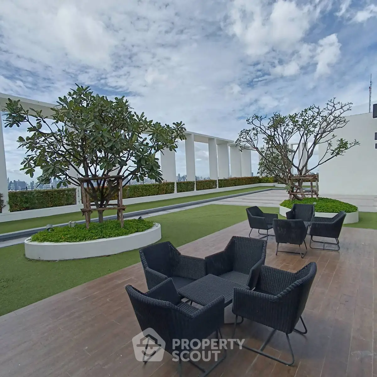 Stunning rooftop terrace with modern outdoor seating and lush greenery, perfect for relaxation and city views.