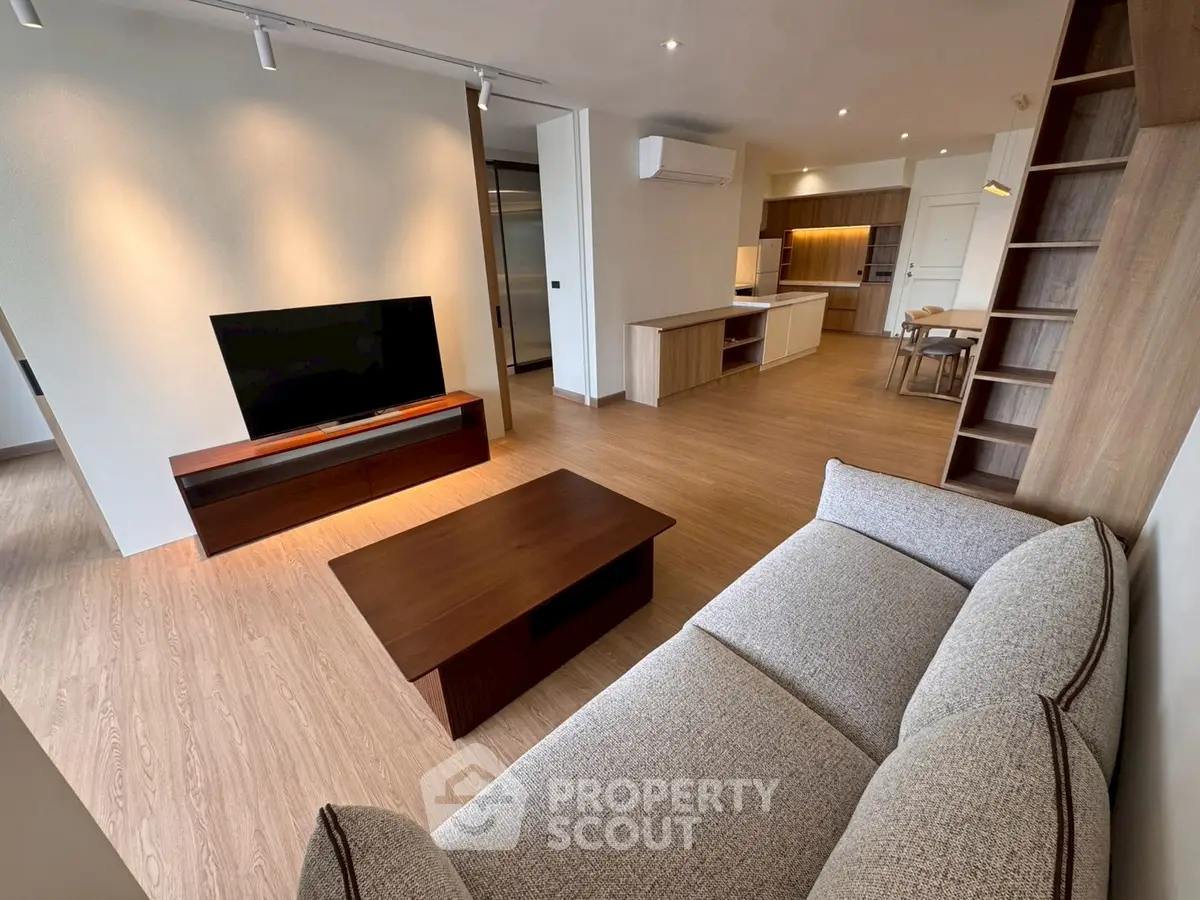 Spacious modern living room with open kitchen layout and stylish furniture