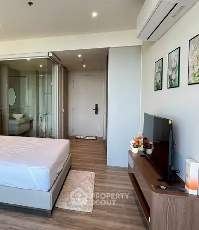 Modern bedroom with ensuite bathroom, featuring sleek decor and air conditioning, ideal for urban living.