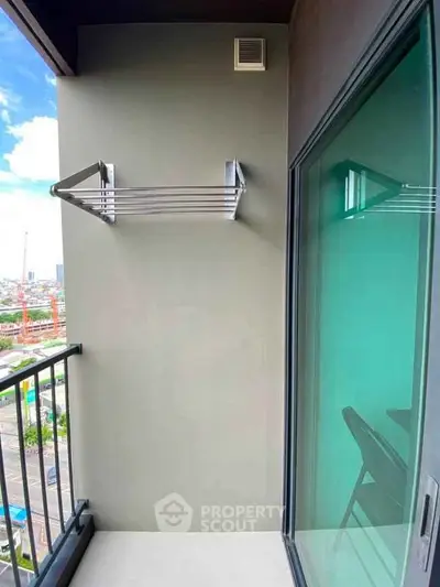 Modern balcony with city view and glass sliding door in urban apartment