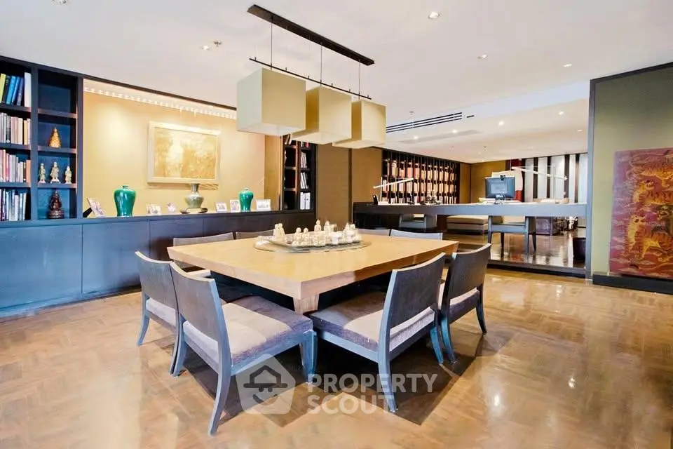 Luxurious dining area with elegant wooden table and modern decor in a spacious open-plan living space.