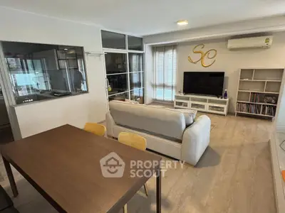 Modern living room with stylish decor and open layout, featuring a cozy sofa and entertainment center.