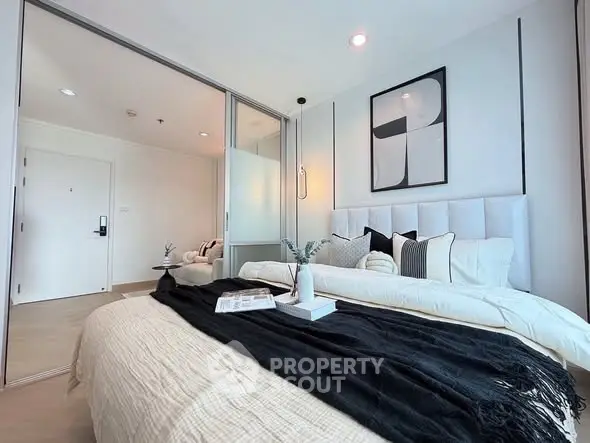 Modern bedroom with stylish decor and cozy ambiance in a contemporary apartment.