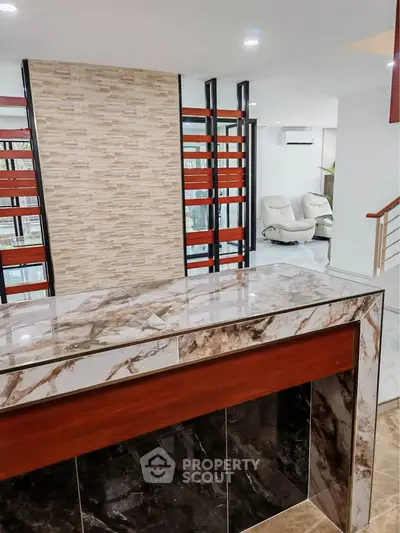 Modern interior with marble accents and stylish partition in a spacious living area.