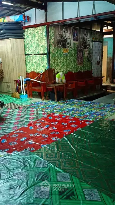Eclectic interior with colorful flooring and wooden furniture in a vibrant living space.