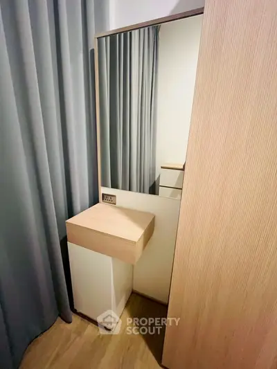 Modern bedroom with sleek wooden wardrobe and stylish mirror