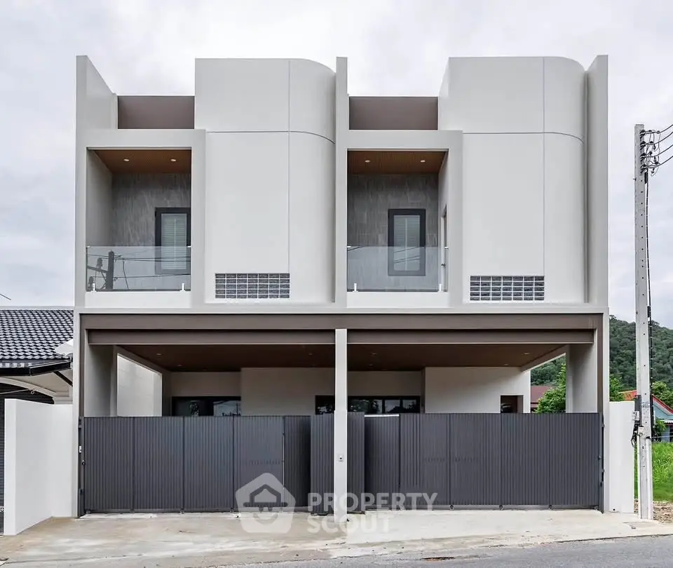 Modern duplex with sleek design and spacious balconies in a serene neighborhood.