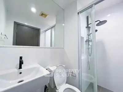 Modern bathroom with sleek fixtures and glass shower enclosure