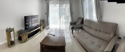 Spacious living room with modern furniture and large windows