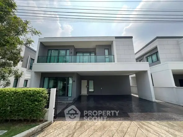 Modern two-story house with sleek design and spacious driveway