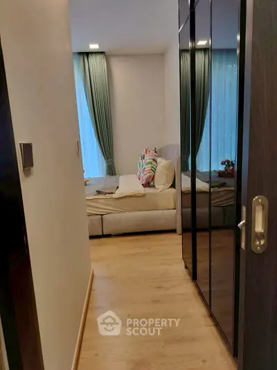 Cozy bedroom with modern decor and large windows for natural light