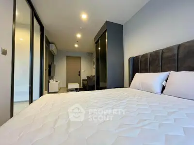 Modern bedroom with sleek design and comfortable bedding in a stylish apartment.