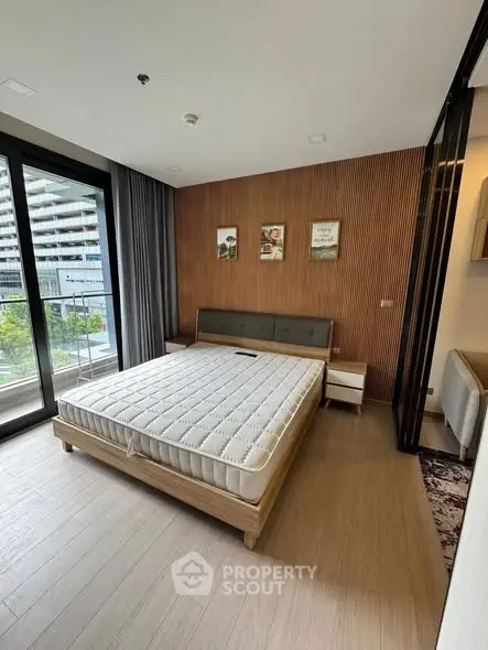 Modern bedroom with large window and wooden accents in luxury apartment