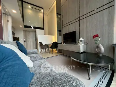 Modern living room with stylish decor and high ceiling, featuring a cozy sofa and elegant dining area.