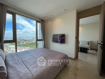 Luxurious bedroom with stunning city view and modern decor in high-rise apartment.
