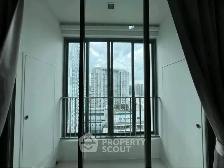 Modern apartment with large windows offering stunning city views