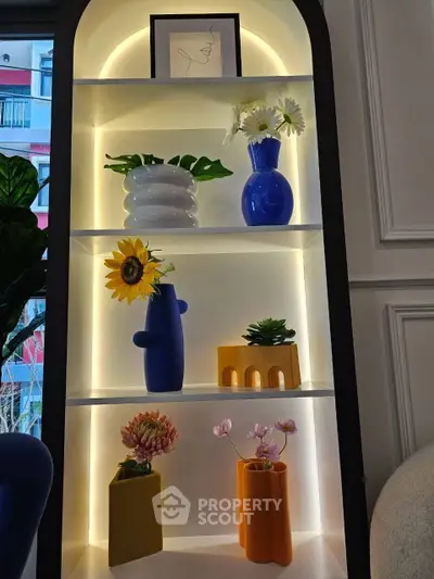 Stylish interior shelf with modern vases and decorative plants, enhancing home elegance.