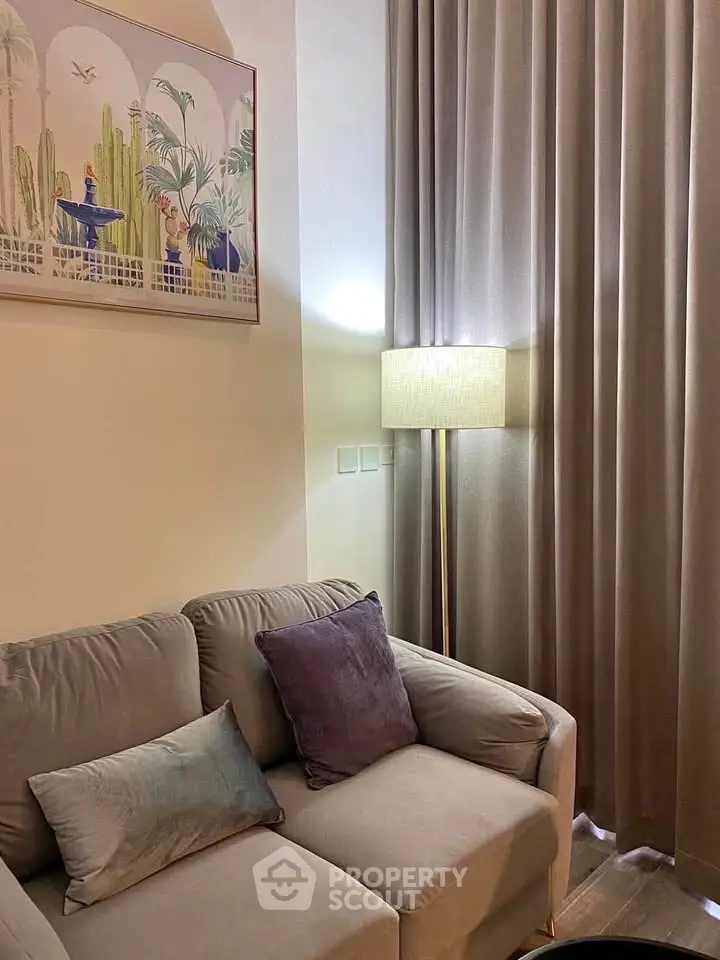 Cozy living room corner with plush sofa and elegant floor lamp, perfect for relaxation.