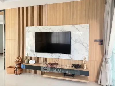 Modern living room with stylish TV setup and elegant wood paneling