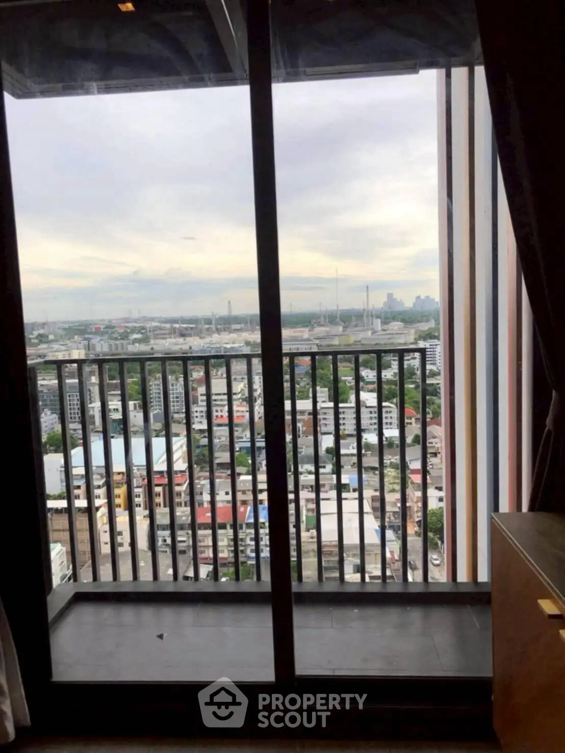 Stunning city view from a high-rise balcony, perfect for urban living.