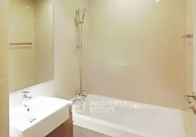 Modern bathroom with sleek bathtub and elegant fixtures in a contemporary apartment.