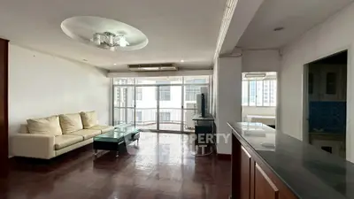 Spacious living room with modern decor and large windows in urban apartment