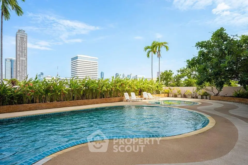 Luxurious rooftop pool with city skyline views and lush greenery, perfect for relaxation and leisure.