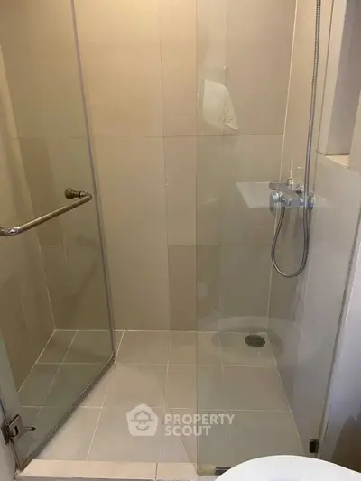 Modern bathroom with glass shower enclosure and sleek fixtures