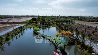 Scenic aerial view of landscaped garden with water features and lush greenery.