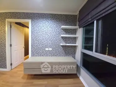 Modern bedroom with stylish wallpaper and built-in shelves, featuring a large window with city view.