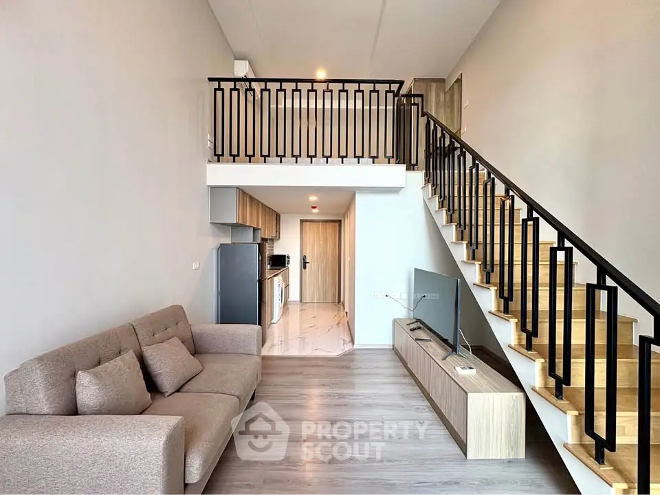Modern loft apartment with open living area and stylish staircase