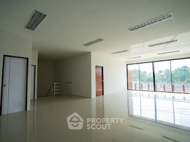 Spacious modern interior with large windows and natural light