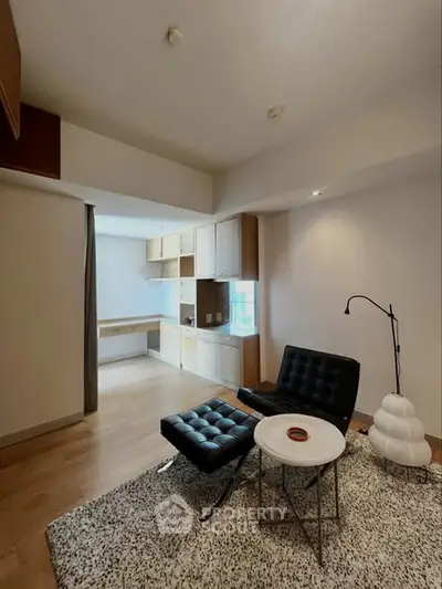 Modern living room with stylish furniture and open kitchen layout